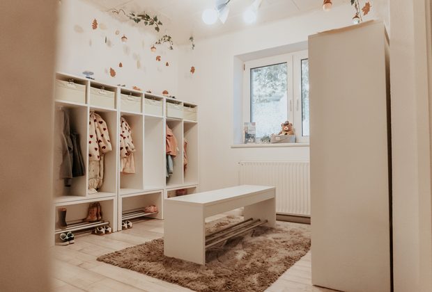 Garderobe mit eigenem Fach für jedes Kind, Bank und Teppich